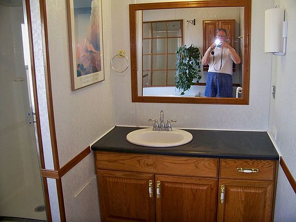 Caught in the act
						:
						The oak bathroom cabnets has a 40 inch X 33 inch mirror