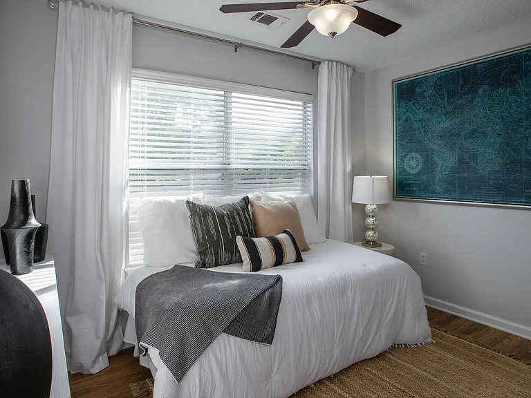 Wake up to the embrace of sunlight in this inviting bedroom at Emerson Isles.