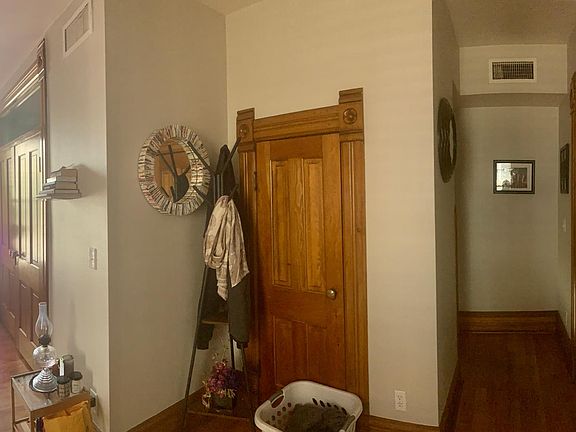 Shows entry way into the living room, closet door and 2nd bedroom door