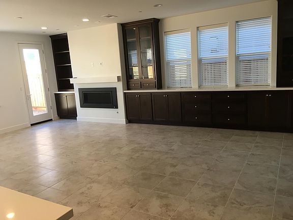 Large open floorplan Living and Dining room. Built-in dining room display cabinets and buffet countertop cabinets.