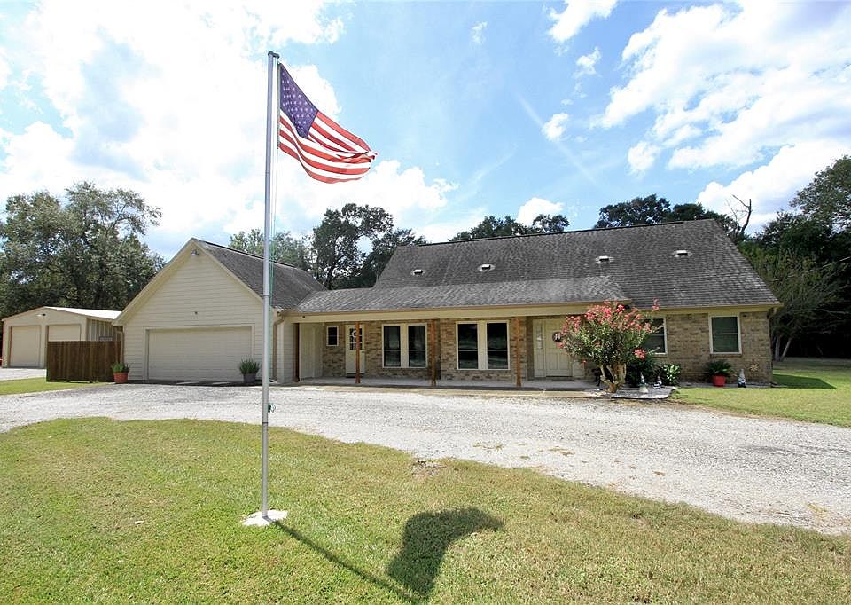 Beautifully Updated One Story, Three Bedroom Home is situated on several acres featuring a Sparkling Pool with a Vast Patio and Covered Patio, Storage Shed, Incredible Custom Garage with an A/C workshop & bathroom and Covered Awning for RV or Boat PL