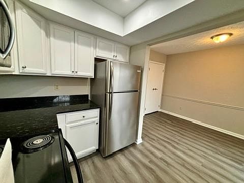 Kitchen with view to the dining area and patio door.