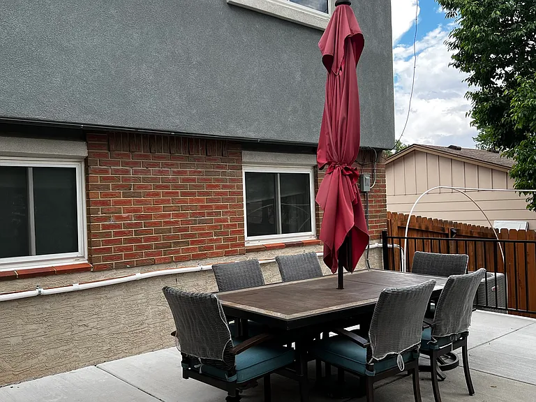 Outdoor patio dining table with seating for six, ideal for meals and gatherings.