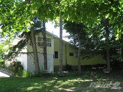 Rear view of building and additional land for parking area.