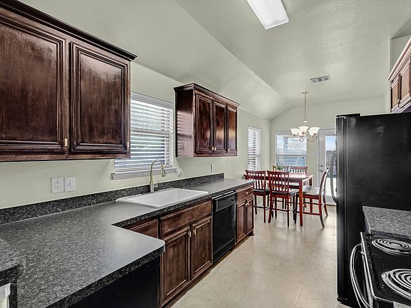 View of the kitchen looking from breakfast area toward the home's foyer