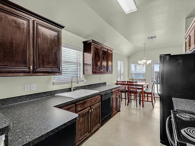 View of the kitchen looking from breakfast area toward the home's foyer