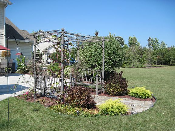 Arbor with plant bed.