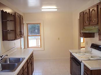 The kitchen includes an electric ovenrange and dishwasher. Ceramic tile flooring in the kitchen and 