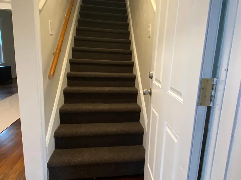 carpeted stairs to second floor