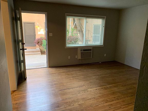 View of living room from the hallway, with entry to kitchen on the left.