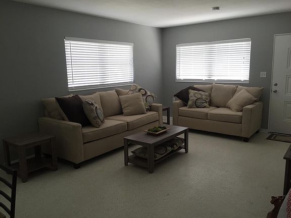 Open and bright living room with large windows and new, mode