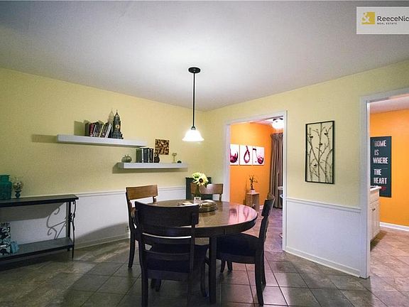 Dining Room with ceramic tile floor and open walls to breakfast space and kitchen.