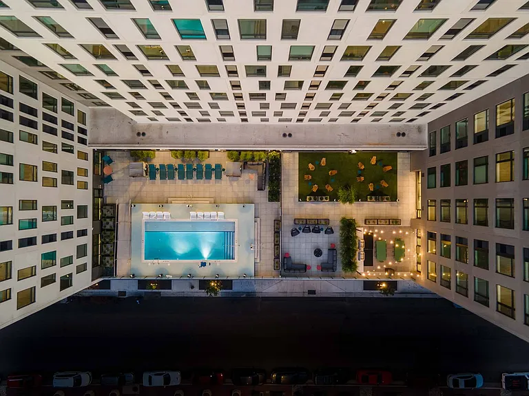 Take in the view of the building's exterior, with a stylish pool patio perfect for relaxation.