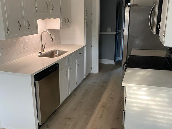 Kitchen with Quartz Countertops and Stainless Steel Appliances.