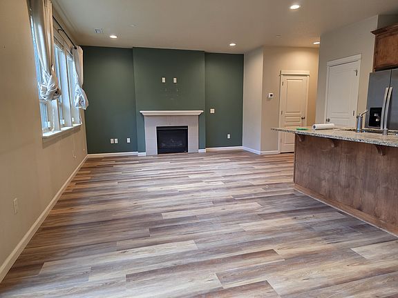 open living room with gas fireplace and new flooring