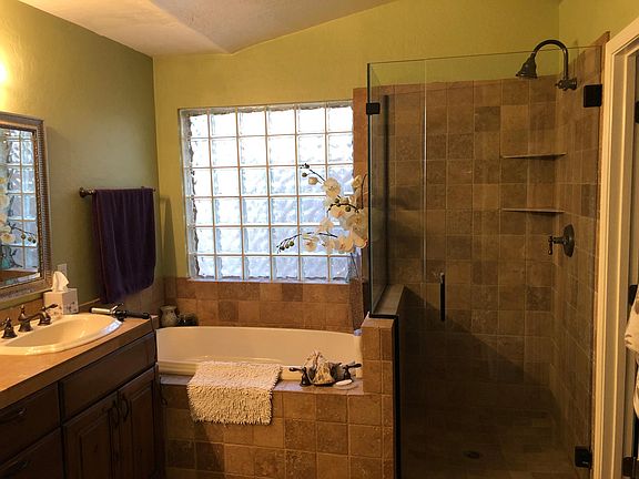 Master bath, spacious custom glass shower and jacuzzi bathtub