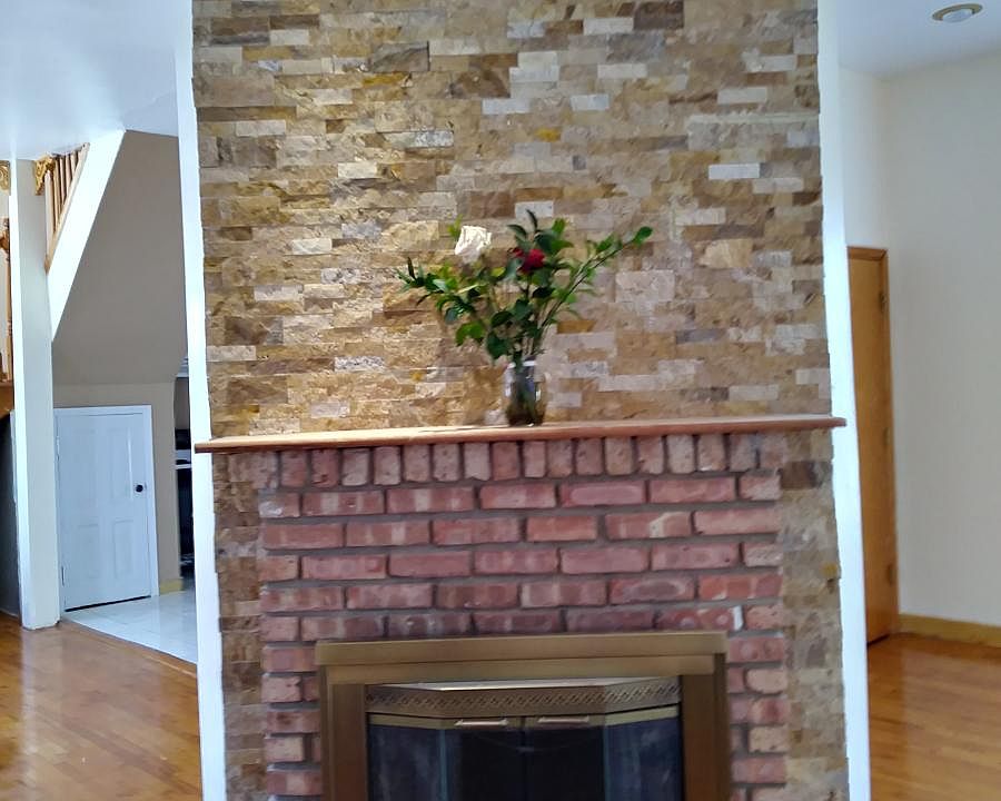 Multi colored rock wall wood burning chimney for winter cudd