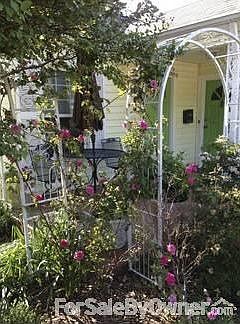 Front porch trellis
						:
						Sturdy, low maintenance roses scent the air of front porch. Comfortable seating.