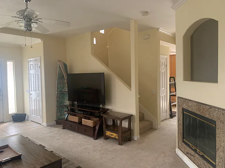 Spacious Living Room with Fireplace/ Staircase