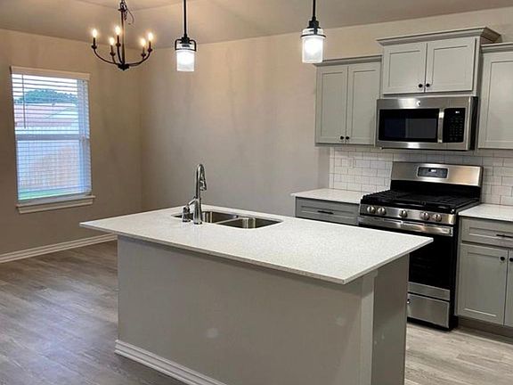 Appliances: Gas stove, microwave/vent, dishwasher, refrigerator with ice machine included