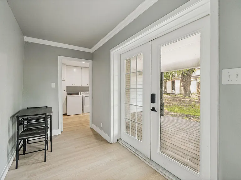 Mudroom-style entry with double glass doors to the deck, plus convenient access to an in-home laundry area.