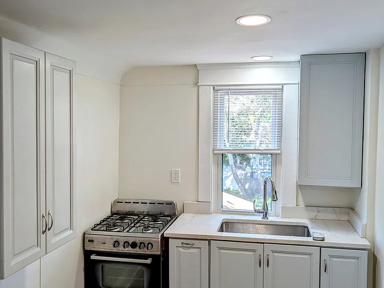 Updated kitchen with new floors, Kraftmaid cabinets, Krauss sink and Moen faucet