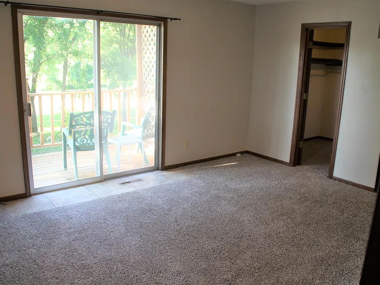 Primary bedroom with private martini deck, walk-in closet and private tiled bathroom with dual vanities and shower.