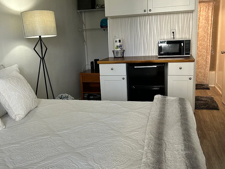 Queen bed , left side is closet and right side is entrance to bathroom.