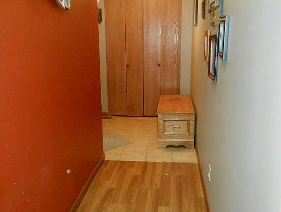 Open entry with tile floors and coat closet