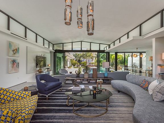 Living room overlooking the water and pool area