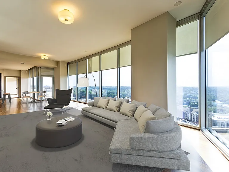 Spacious living room features floor-to-ceiling windows with amazing views of Buckhead