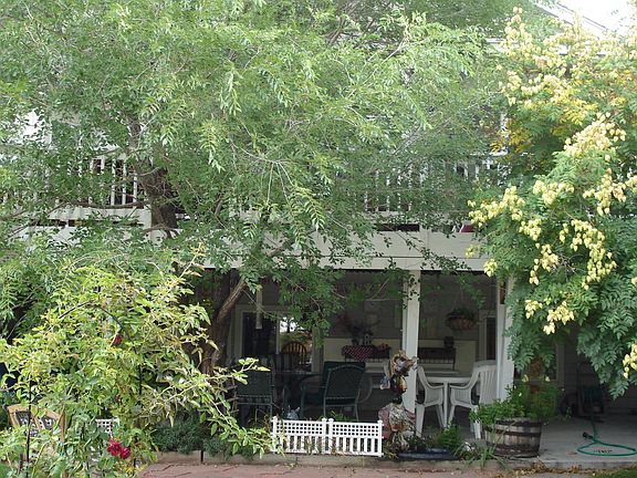 view from pond toward back of house, patio and deck