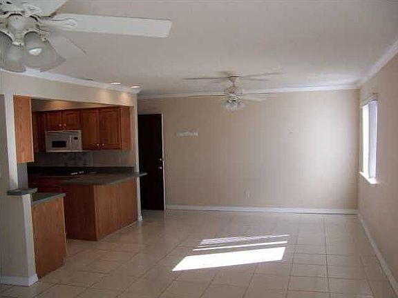 Open, bright living rm with ceiling fans and easy care tile floors