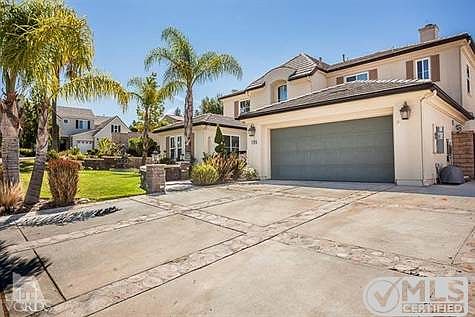 Stone accented driveway. 3-car tandem garage.