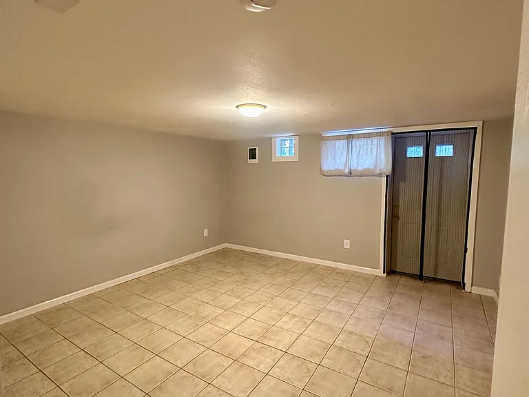 5th bedroom with exterior door to backyard