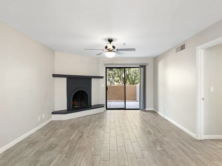 Updated living room with tile floors and wood burning fireplace