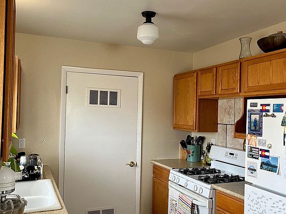 gally kitchen with door to walk in pantry