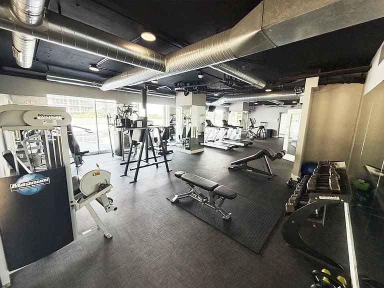 Fully equipped fitness center with cardio machines, free weights, and strength equipment_no gym membership needed
