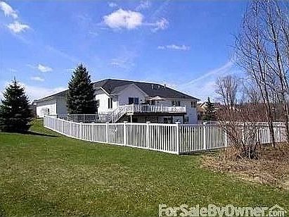 Back of house : Rear of house with PVC fencing, upper level deck, lower level walk out to patio