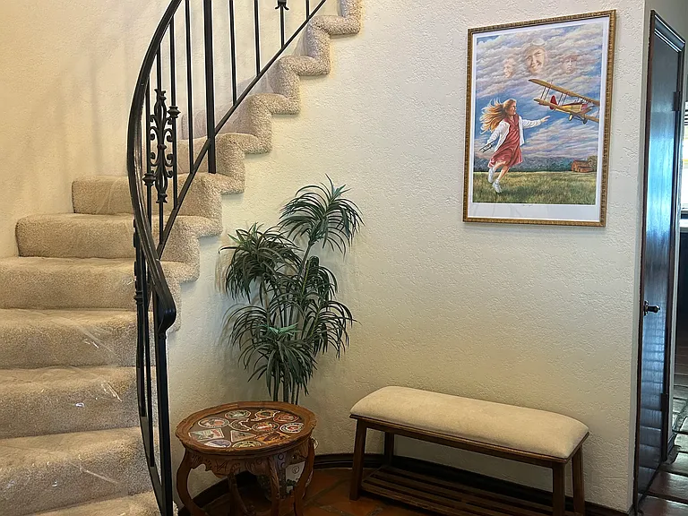 Entry way into the house. Small bathroom is to the left; living room to the right.