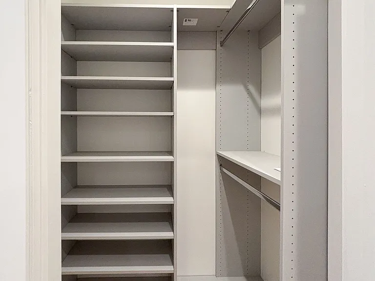Close up of walk-in closet in primary bedroom