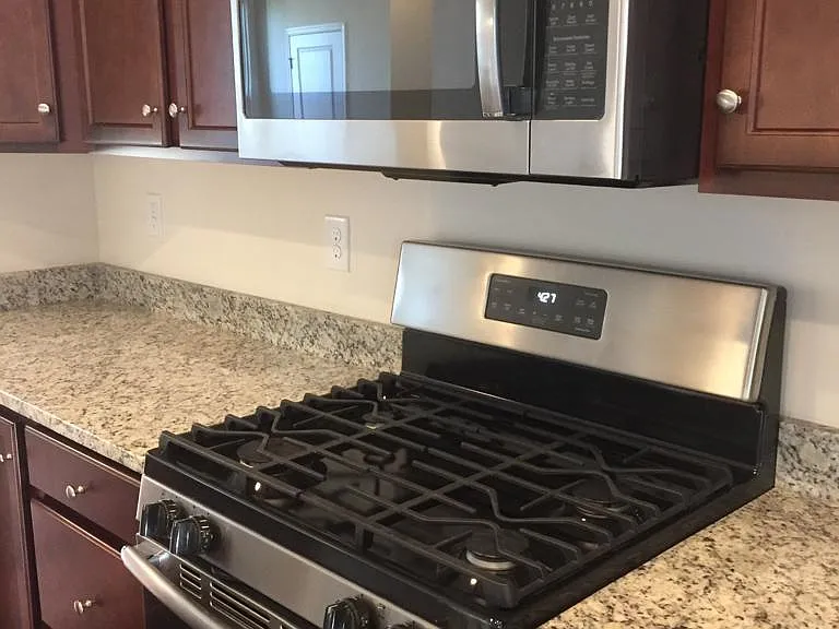 kitchen with granite top and SS appliances.