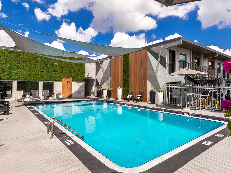 Bask in the Florida sunshine on the expansive sundeck which is complemented by shaded areas, modern lounge chairs, and vibrant landscaping, offering the ultimate relaxation spot for residents.