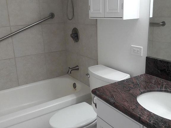 Porcelain tile in tub, granite countertop, lots of storage