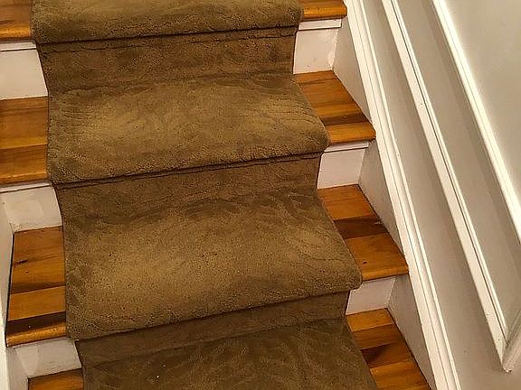 Wood stairs,carpeted runner 
