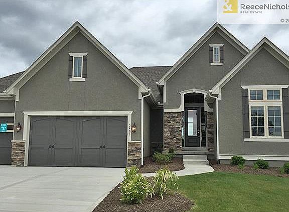 Sallee homes "Terry" plan.  Stucco front with stone accents and carriage style garage doors. Actual exterior color will be shades of gray.  Still time to pick your custom landscaping!