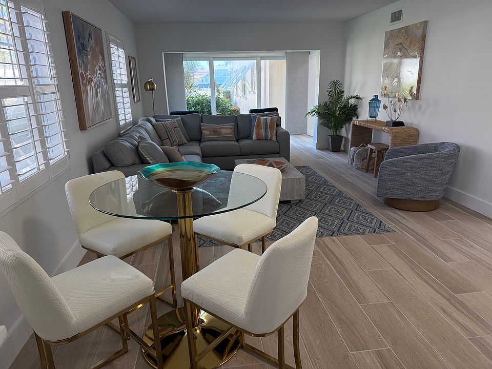 Bright and airy living room with an adjacent lanai looking out to the Bay.