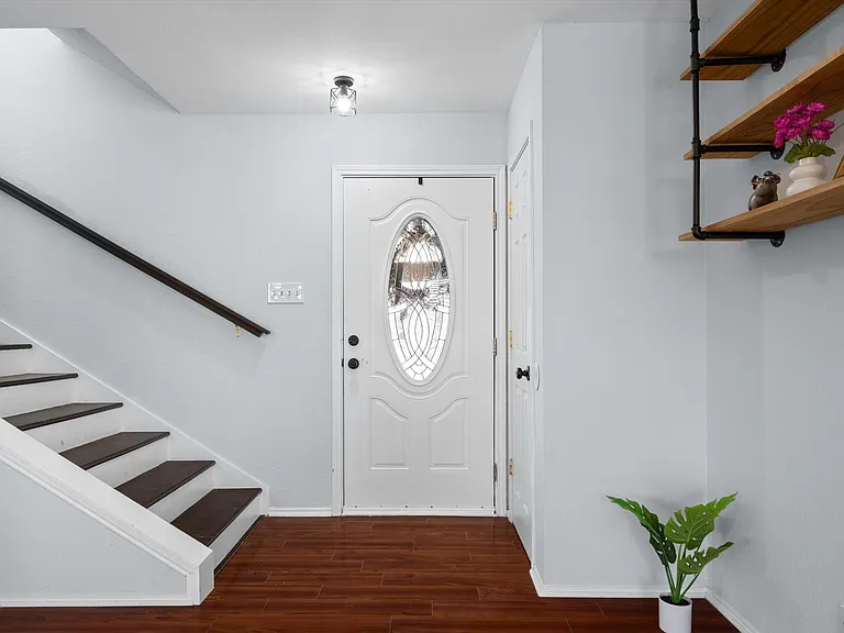 A generous entry hall leads into the living room.