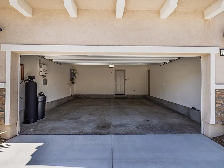 Spacious two-car garage with ample storage and a whole-house water filtration system installed for cleaner, better-quality water throughout the home. Well-lit and move-in ready, providing convenience and functionality for modern North Menifee living.