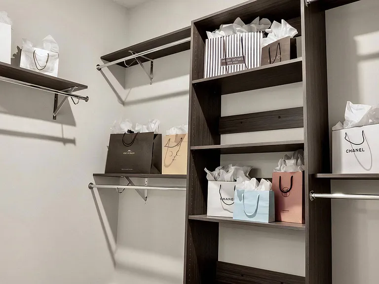 Closet Interior Featuring Built-In Shelves and Multiple Storage Racks